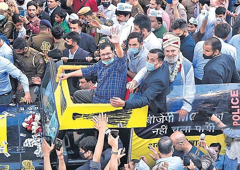 Kejriwal waves at supporters during a roadshow ahead of upcoming MCD bypolls, at Seelampur on Thursday | Shekhar Yadav