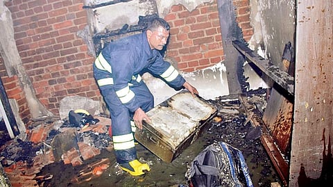 A fire personnel dousing flames at the house in Cuttack | Express