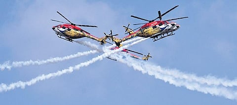 The Sarang helicopter air display team carries out a breathtaking manoeuvre during the inauguration of Aero India 2021 at the Yelahanka Air Force Station in Bengaluru on Wednesday | VINOD KUMAR T