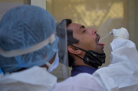 A health worker collects a swab sample from a man to test for the Covid-19 coronavirus. (Photo| AFP)
