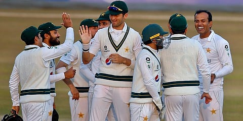 Pakistan's Nauman Ali (R) celebrates with teammates after taking the wicket of South Africa's Aiden Markram during the second day of the second cricket Test match in Rawalpindi. (Photo | AP)