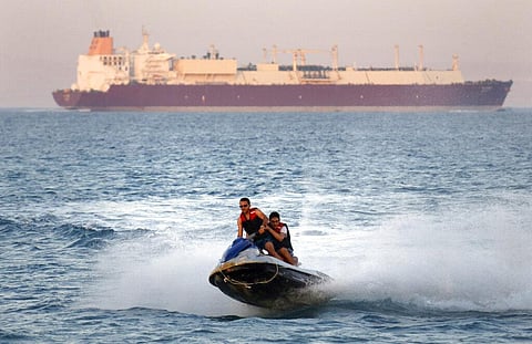 In this Friday, July 26, 2019 file photo, a ship crosses the Gulf of Suez towards the Red Sea as holiday-makers ride a jet ski at al Sokhna beach in Suez, 127 kilometers east of Cairo. (Photo | AP)