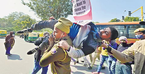 Police take away a protester near Shaheedi Park on Saturday | PTI