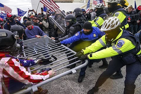 Violent insurrectionists loyal to President Donald Trump supporters try to break through a police barrier at the Capitol in Washington. (File photo | AP)