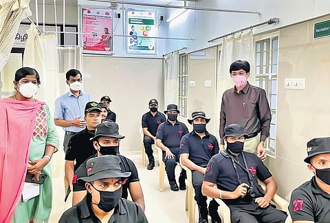 Black cats of the National Security Guard (NSG) wait for their turn to receive the Covid-19 vaccine in Chengalpet on Saturday. (Photo | EPS)