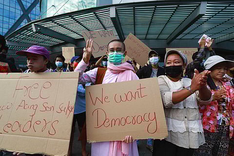 A Buddhist nun flashes the three-fingered salute as protesters gather outside the Hledan Center in Yangon, Myanmar. (Photo | AP)