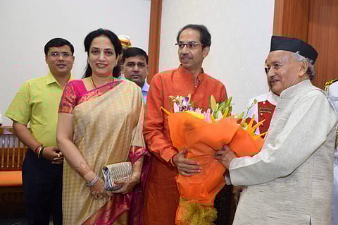 Maharashtra Governor Bhagat Singh Koshyari receives a bouquet from state Chief Minister-designate Uddhav Thackeray and his wife Rashmi Thackeray at Raj Bhavan in Mumbai Wednesday Nov. 27 2019. (Photo