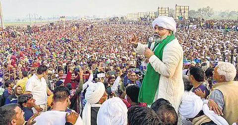 BKU leader Rakesh Tikait addresses a kisan mahapanchayat in Haryana’s Jind dist on Wednesday. (Photo | PTI)