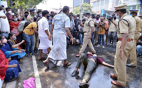 Praveen Kumar, a last grade PSC rank holder poured kerosene himself threatening suicide lying on the road in front of Secretariat demadning immeodate appointments. (Photo | Vincent Pulickal, EPS)