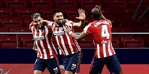 Atletico Madrid's Luis Suarez (C) celebrates with teammates after scoring during a La Ligamatch against Celta at Madrid. (Photo| AP)