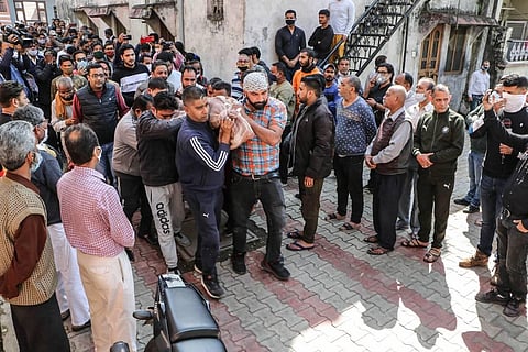 Family members of 22-year-old Aakash Mehra who was shot and injured by militants on February 17 in Srinagar carry his mortal remains for cremation at Janipur Colony in Jammu Sunday. (Photo | PTI)