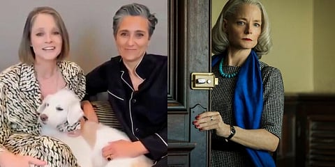 Jodie Foster, left, holding her dog Ziggy, accepts the award for best supporting actress in a motion picture for 'The Mauritanian' as her wife Alexandra Hedison looks on at right at the Golden Globe A