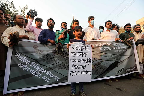 Police use tear gas shells on demonstrators protesting the death in prison of a writer in Bangladesh. (Photo| AP)
