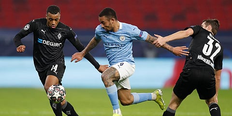 Manchester City's Gabriel Jesus (C) is challenged by Moenchengladbach's Alassane Plea (L) and Florian Neuhaus during a Champions League match. (Photo| AP)