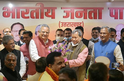 BJP central observer Raman Singh greets party leader Tirath Singh Rawat after being elected as the new Chief Minister of Uttarakhand in Dehradun. (Photo | PTI)