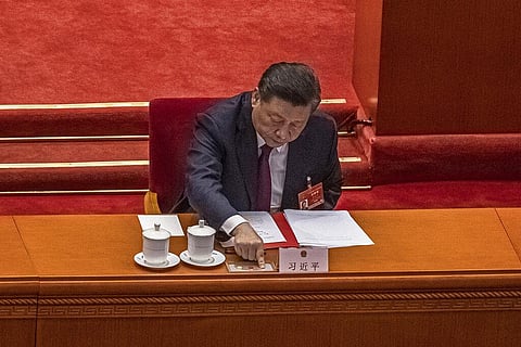 Chinese President Xi Jinping presses a button to vote on a proposal to draft changes of election rules for Hong Kong during the closing session of the National People's Congress. (Photo | AP)