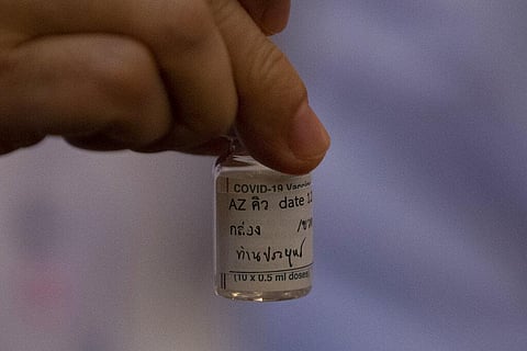 A health worker holds a bottle of AstraZeneca COVID-19 vaccine with name Thailand's Prime Minister Prayuth Chan-ocha written on it, at Bamrasnaradura Hospital in Bangkok. (Photo | AP)