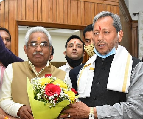 Chief Minister Tirath Singh Rawat meets BJP State President Madan Kaushik after his appointment. (Photo| EPS)