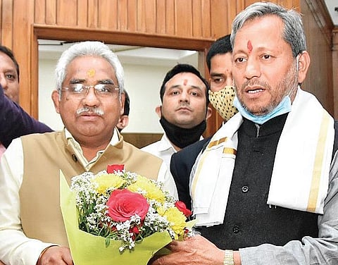 CM Tirath Singh Rawat (R) with state BJP chief Madan Kaushik on Friday | express