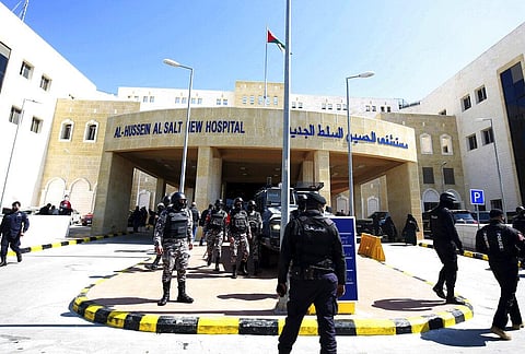 Soldiers stand guard outside Al-Hussein Al Salt Hospital in Salt, Jordan. (Photo| AP)