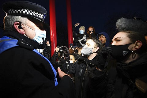 People react with police, in Clapham Common as people gather, despite the Reclaim These Streets vigil for Sarah Everard being officially cancelled, in London. (Photo | AP)
