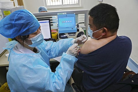 A nurse gives a shot of the Sinopharm COVID-19 vaccine to a man at a community health station in Nantong in east China (Photo | AP)