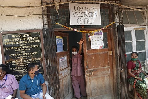 A health worker calls name of a person who is to receive COVID-19 vaccine in Mumbai, India, Wednesday, March 10, 2021. (Photo | AP)