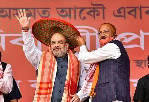 Home Minister Amit Shah being presented an 'Assamese Japi' during an election campaign rally ahead of the Assam Assembly Polls at Margherita in Tinsukia District. (Photo | PTI)