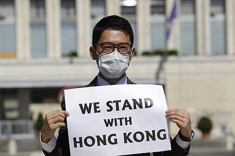 Hong Kong activist Nathan Law takes part in a protest during a meeting of Chinese Foreign Minister Wang Yi with Italian Foreign Minister Luigi Di Maio, in Rome. (Photo | AP)