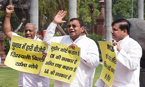 AAP MPs Sanjay Gandhi (R), Sushil Gupta stage a protest in front of Mahatma Gandhi statue at Parliament complex, during the onoging budget session on Wednesday. (Photo | PTI)