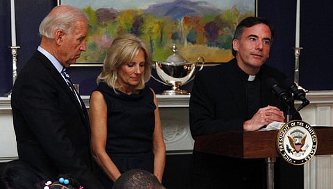 File photo of ex-VP Joe Biden(L), his wife, Jill Biden, standing with heads bowed as the Rev. Kevin O'Brien says blessing during Thanksgiving meal for Wounded Warriors. (Photo | AP)
