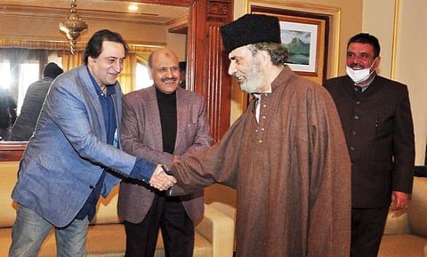 Former Peoples Democratic Party patron Muzaffar Hussain Baig is greeted by J&K People's Conference Chairman Sajad Gani Lone after he joined PC party in Srinagar on Wednesday. (Photo | PTI)