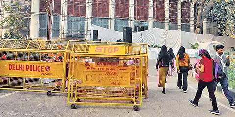 People walk past the under-construction site of Delhi City Museum at Dara Shikoh Library. (Photo | EPS)