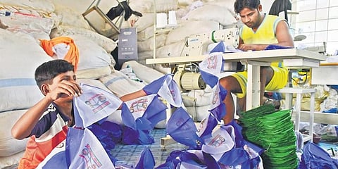 Workers making caps with YSRC symbols and leaders’ pictures at Tadepalli on Monday ahead of the March 10 municipal elections. (Photo | Prasant Madugula, EPS)