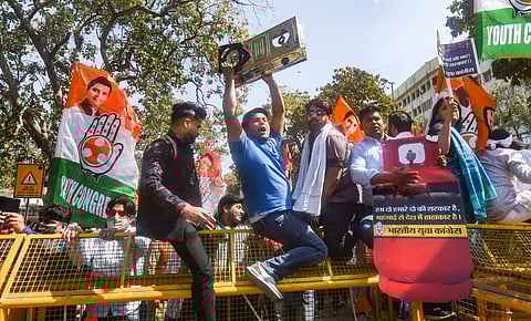 Indian Youth Congress IYC workers stage a protest against the price hike of cooking gas and fuel in New Delhi Tuesday. (Photo | PTI)