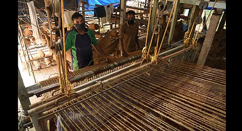 Coir workers Udayan and Saji weaving geotextile mats at a small-scale unit at Kanjikuzhy in Alappuzha. (Photo | Albin Mathew, EPS)
