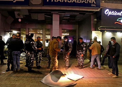 Lebanese security forces inspect the entrance of a Fransabank branch. (Photo| AFP)