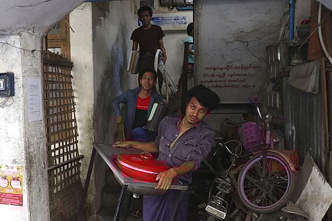 State railway employees carry their belongings after being evicted from their home in Mandalay, Myanmar. (Photo | AP)