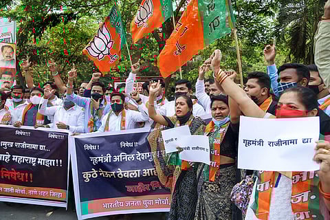 Bharatiya Janata Yuva Morcha activists protest against Maharashtra Home MInister Anil Deshmukh over allegations made by ex-Mumbai Police commissioner Parambir Singh, in Thane, Sunday. (Photo | PTI)
