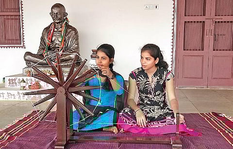 Students learn to use the charkha at Sabarmati Ashram replica in Gadag