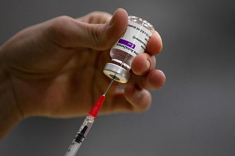 A pharmacist prepares a syringe from a vial of the AstraZeneca coronavirus vaccine (Photo | AP)