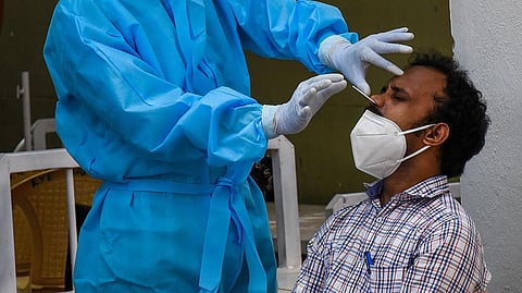 A health worker collects a swab sample from a man to test for Covid-19 (Photo| M K Ashok Kumar, EPS)