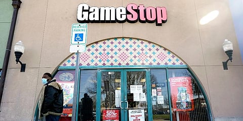 A pedestrian passes a GameStop storefront in Dallas. (Photo | AP)