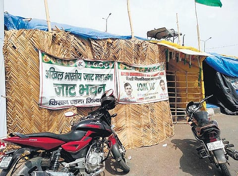 Green mosquito nets and airy bamboo huts being installed for the summer