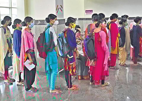 Nursing students stand in a queue to get themselves immunised against Covid-19 at New Government General Hospital in Vijayawada on Wednesday | P Ravindra Babu