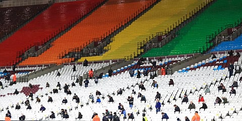 Fans are socially distanced as they wait for kick off ahead of the English Premier League match between West Ham United and Manchester United at the London stadium. (File Photo | AP)