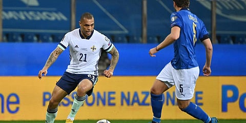 Northern Ireland's Josh Magennis (L) competes for the ball with Italy's Manuel Locatelli (R) during the World Cup 2022 qualifier Group C soccer game in Parma. (Photo| AP)