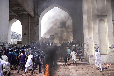 Security officers arrive as two factions of protestors clash after Friday prayers at Baitul Mokarram mosque in Dhaka (Photo | AP)