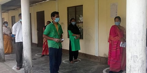 People wait to cast their vote at a polling booth in West Bengal. (Photo | ANI)