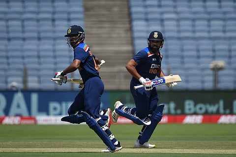 India's Shikhar Dhawan (L) and Rohit Sharma run between the wickets during final ODI match against England at the MCA Stadium in Pune on March 28, 2021. (Photo | AFP)